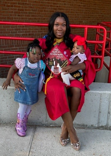 Guyshana posing with her two daughters on graduation day