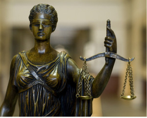 blindfolded justice holding scales